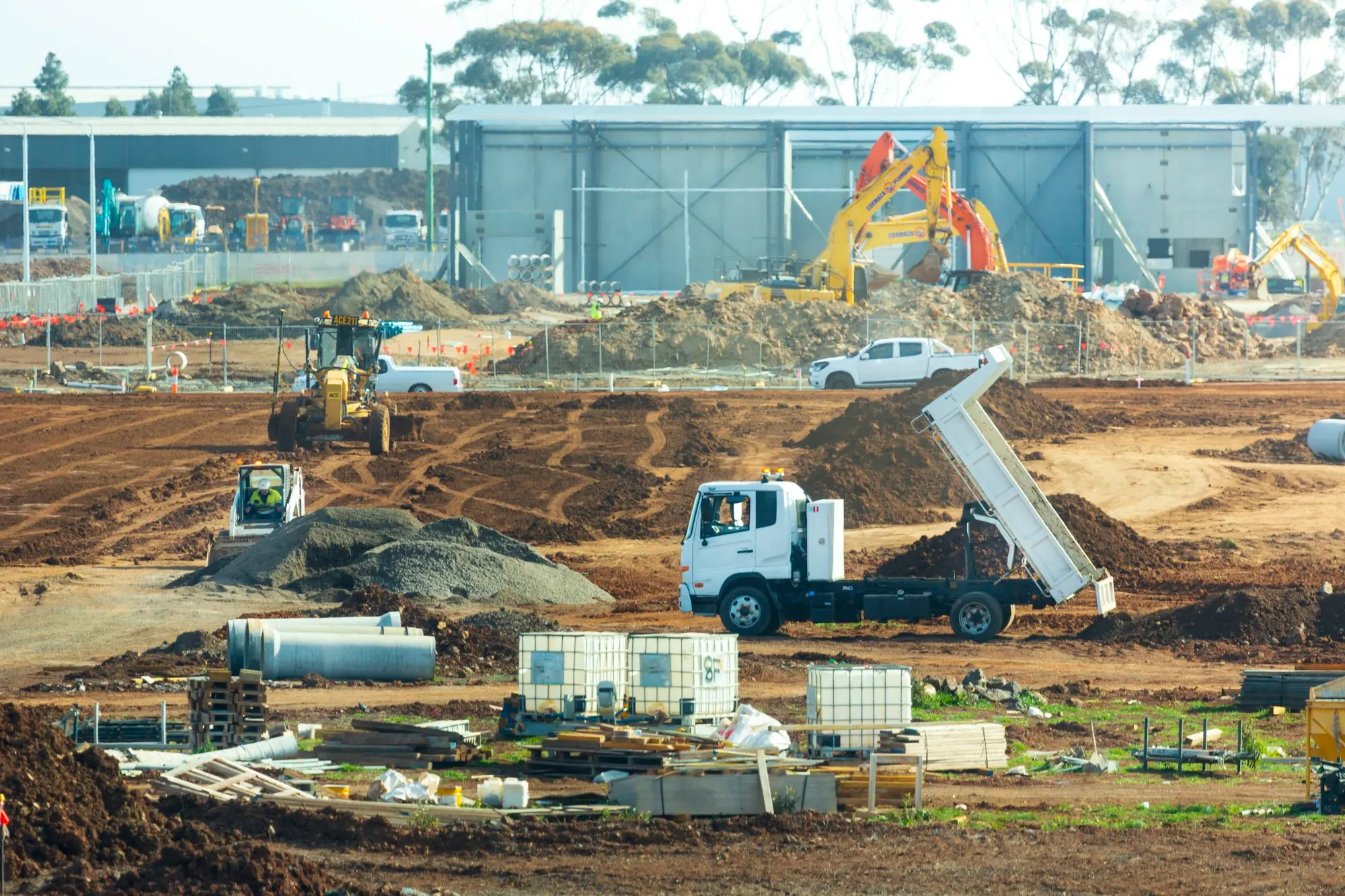 Construction site with trucks and earthmoving equipment at work