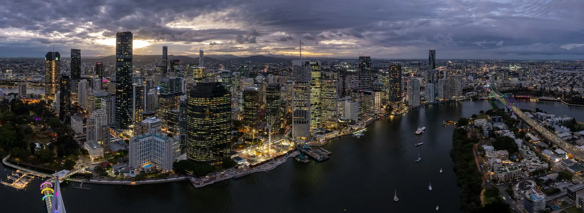 Brisbane city skyline at dusk with the river and a bridge