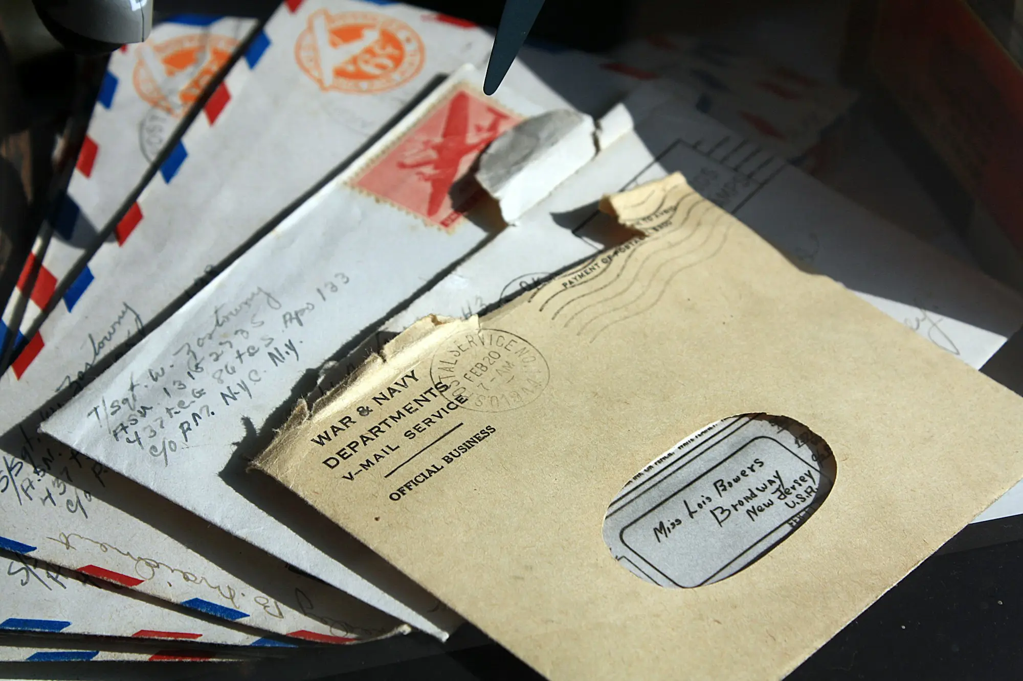 Small pile of opened envelopes and letters on a desk