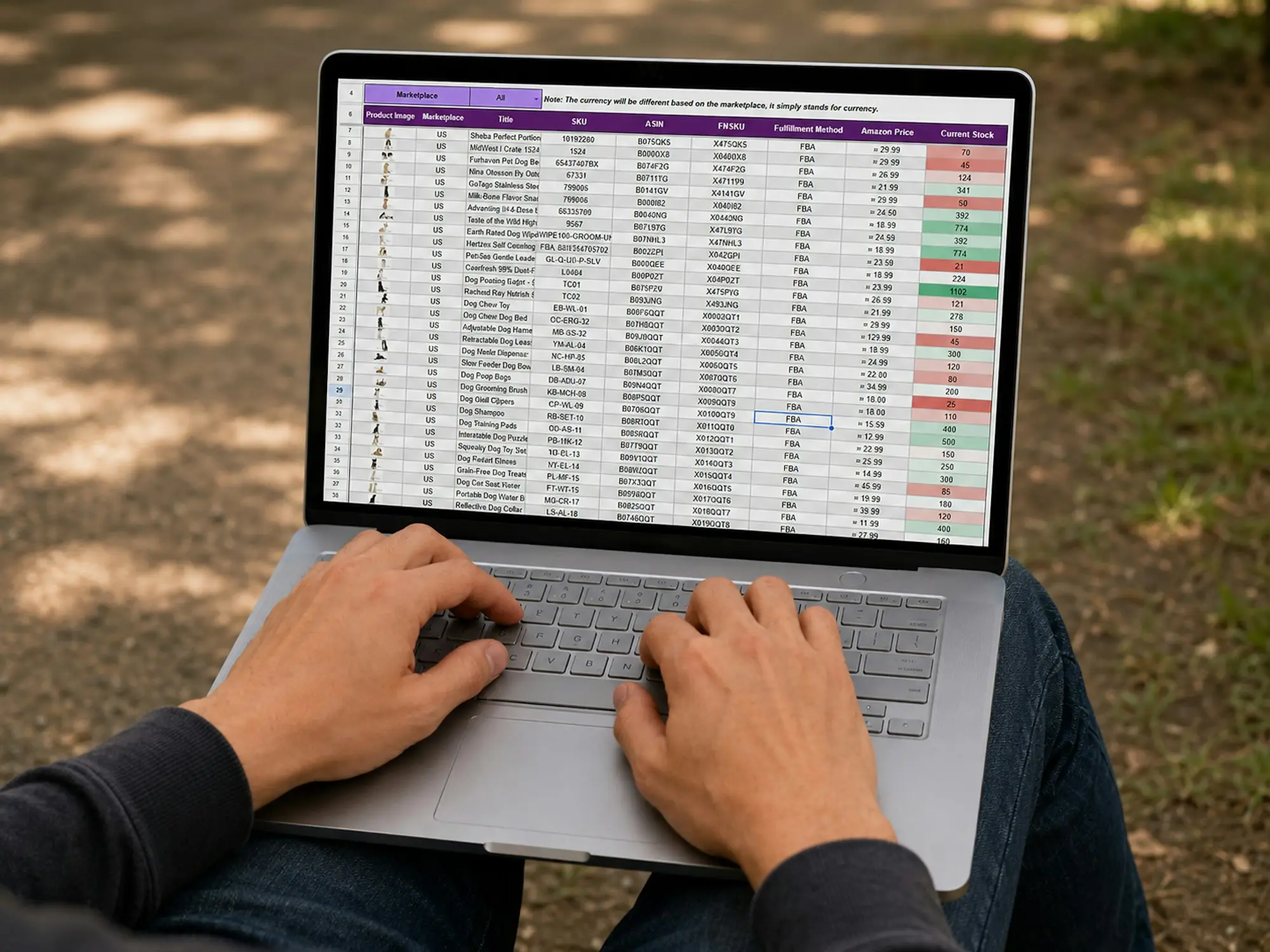 Person working on a laptop spreadsheet at an outdoor table